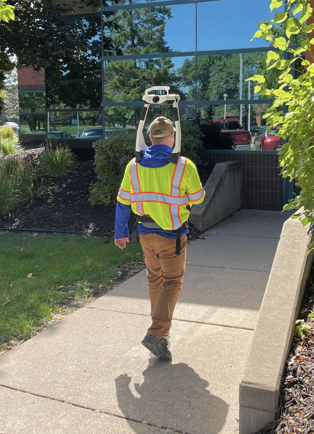 man wearing slam device technician wearing SLAM laser scanning device